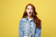 Close up Portrait amaze young beautiful attractive redhair girl shocking with something. Isolated on Bright Yellow stock photography Close up Portrait amaze young beautiful attractive redhair girl shocking with something. Isolated on Bright Yellow stock photography