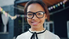 Close-up portrait of attractive African American teenager in glasses smiling stock video footage Close-up portrait of attractive African American teenager in glasses smiling stock video footage