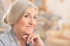 Portrait of beautiful senior woman smiling at home stock photos Portrait of beautiful senior woman smiling at home stock photos