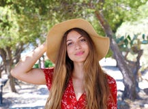 Close up portrait of a beautiful smiling girl with brown hair wearing a hat and looking at camera outdoors royalty free stock photography Close up portrait of a beautiful smiling girl with brown hair wearing a hat and looking at camera outdoors royalty free stock photography