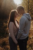 Close up portrait of beautifull couple is staying in the autumn forest. Colored autumn stock photo Close up portrait of beautifull couple is staying in the autumn forest. Colored autumn stock photo