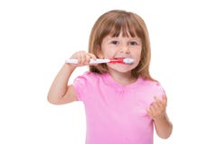Close-up portrait Cute little girl 3 year old in pink t-shirt brushing her teeth isolated on white background stock photo Close-up portrait Cute little girl 3 year old in pink t-shirt brushing her teeth isolated on white background stock photo