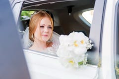 Close-up Portrait Of A Beautiful Bride In A Wedding Car Window. The Concept Of Wedding Happiness. Stock Image