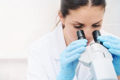 Close Up Portrait Of Young Medical Researcher Looking Through Mi Stock Photography