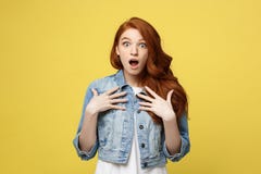 Close up Portrait young beautiful attractive redhair girl shocking with something. Golden yellow Background. Copy space. stock image Close up Portrait young beautiful attractive redhair girl shocking with something. Golden yellow Background. Copy space. stock image