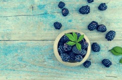 Close up of ripe blackberries over rustic turquoise wooden table royalty free stock photography Close up of ripe blackberries over rustic turquoise wooden table royalty free stock photography