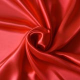 Close up of ripples in shape of rose flower on red silk fabric. Stock Images Close up of ripples in shape of rose flower on red silk fabric. Stock Images