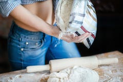 Close-up of girl belly, dough, flour bag and rolling pin. young woman prepares dough in the kitchen royalty free stock photo Close-up of girl belly, dough, flour bag and rolling pin. young woman prepares dough in the kitchen royalty free stock photo