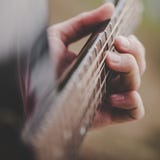 Hand taking a chord on acoustic guitar - close up royalty free stock images Hand taking a chord on acoustic guitar - close up royalty free stock images