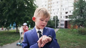 Close Up shot of smart watch with black strap on a hand of child in business suit. Sport smart wrist using
