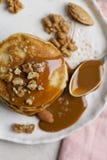 Close up stack of pancakes with caramel and nuts with spoon royalty free stock photo Close up stack of pancakes with caramel and nuts with spoon royalty free stock photo