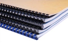 Close-up of a stack of spiral notebooks / reports