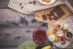 Close-up of sweets on a white plate: coconut pechente, pastila, meringue, cream roses, razat Turkish delight, near a broken royalty free stock images Close-up of sweets on a white plate: coconut pechente, pastila, meringue, cream roses, razat Turkish delight, near a broken royalty free stock images