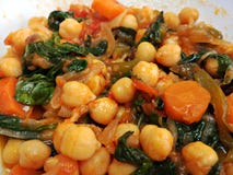 Spinach and chickpea stew on a white plate stock photography Spinach and chickpea stew on a white plate stock photography