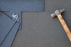 Close up view on asphalt shingles on a roof with hammer and nails background Royalty Free Stock Photo Close up view on asphalt shingles on a roof with hammer and nails background Royalty Free Stock Photo