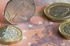 British coins set on a Ten Euro banknote stock photos British coins set on a Ten Euro banknote stock photos
