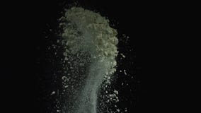 Close-up view of grey powder particles flying on the black background. Stock footage. Contrast of white and black stock photography Close-up view of grey powder particles flying on the black background. Stock footage. Contrast of white and black stock photography