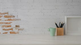 Close Up View Of Workplace With Mug, Mock-up Frame, Stationery And Copy Space On Marble Desk Stock Photography