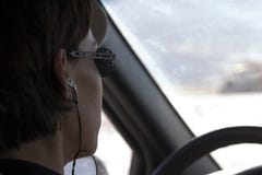 Close up on a woman driving with a headset on Royalty Free Stock Photo Close up on a woman driving with a headset on Royalty Free Stock Photo