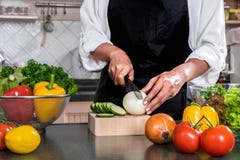 Close up of woman hand cutting onion on chopping wood board with royalty free stock image Close up of woman hand cutting onion on chopping wood board with royalty free stock image
