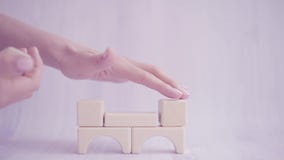 Close up of woman hands establish or build a toy house with wooden blocks. Strong family concept. Business growth, house stock video Close up of woman hands establish or build a toy house with wooden blocks. Strong family concept. Business growth, house stock video