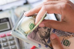 Close up woman hands holding and counting bunch of America dollars stock image Close up woman hands holding and counting bunch of America dollars stock image