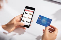 Woman Holding Credit Card In Hand Doing Online Shopping