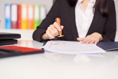 Close up on woman's notary public hand stamping the document stock photo Close up on woman's notary public hand stamping the document stock photo
