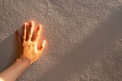 Close up women hand touches a white concrete wall with sunshine, shade and shadow in the morning. Copy space for text. royalty free stock photo Close up women hand touches a white concrete wall with sunshine, shade and shadow in the morning. Copy space for text. royalty free stock photo