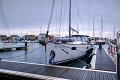 Close-Up of Yacht Moored in Sovereign Harbor With Yachts, Boats and New-Build Apartments in Background royalty free stock photo Close-Up of Yacht Moored in Sovereign Harbor With Yachts, Boats and New-Build Apartments in Background royalty free stock photo