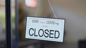 Closed sign hanging on door of cafe due to Covid-19