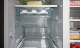 Closed up white side by side ice maker and ice tray in new freezer. royalty free stock photos Closed up white side by side ice maker and ice tray in new freezer. royalty free stock photos