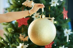 Closeup on big gold Christmas ball in a hand of woman stock photos Closeup on big gold Christmas ball in a hand of woman stock photos
