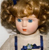 Closeup of a blonde porcelain doll on white background, vintage toys stock photo Closeup of a blonde porcelain doll on white background, vintage toys stock photo