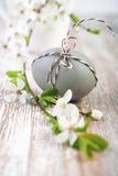 Closeup on brown Easter egg tied with checkered cord with white royalty free stock image Closeup on brown Easter egg tied with checkered cord with white royalty free stock image