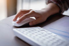 Closeup of Businesswoman`s hand holding a computer mouse. Techno stock photo Closeup of Businesswoman`s hand holding a computer mouse. Techno stock photo