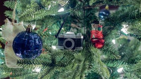 Closeup of camera and snowman decoration on Christmas tree. royalty free stock photography Closeup of camera and snowman decoration on Christmas tree. royalty free stock photography