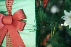 Closeup on Christmas gift in hand of woman near Christmas tree royalty free stock photos Closeup on Christmas gift in hand of woman near Christmas tree royalty free stock photos