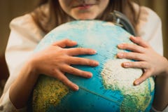 Closeup of cute girl holding hands on Earth globe. Concept of en Stock Image Closeup of cute girl holding hands on Earth globe. Concept of en Stock Image