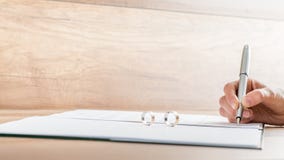 Closeup of female hand signing divorce papers stock image Closeup of female hand signing divorce papers stock image