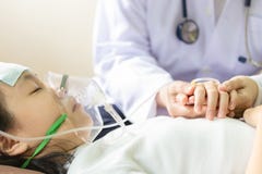 Closeup of hand female caregiver holding with little girl hands,cute child patient putting inhalation or oxygen mask in hospital stock images Closeup of hand female caregiver holding with little girl hands,cute child patient putting inhalation or oxygen mask in hospital stock images