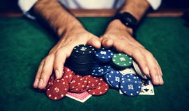 Closeup of hands with gambling tokens and card royalty free stock image Closeup of hands with gambling tokens and card royalty free stock image