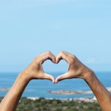 Man forming a heart with his hands in Corsica royalty free stock images Man forming a heart with his hands in Corsica royalty free stock images
