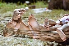 Closeup of happy family lying on hammock barefoot stock photos Closeup of happy family lying on hammock barefoot stock photos