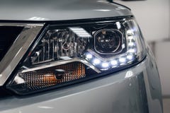 Closeup headlights of a modern car. Detail on the front light of a car stock image Closeup headlights of a modern car. Detail on the front light of a car stock image