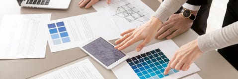 Closeup interior designers working with color swatches palette and blueprint stock photography Closeup interior designers working with color swatches palette and blueprint stock photography