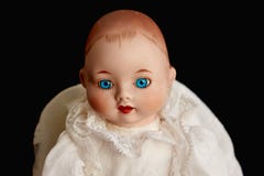 Closeup of old porcelain doll with blue eyes on black background Royalty Free Stock Photos Closeup of old porcelain doll with blue eyes on black background Royalty Free Stock Photos