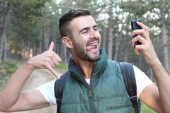 Closeup on person using smart phone and showing thumb up finger while making a video call or taking a selfie royalty free stock image Closeup on person using smart phone and showing thumb up finger while making a video call or taking a selfie royalty free stock image