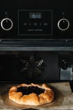 Closeup photo of galette with black currant baking in a oven royalty free stock photo Closeup photo of galette with black currant baking in a oven royalty free stock photo