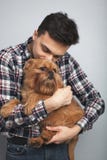 Closeup portrait handsome young hipster man, kissing his good friend red dog isolated light background. Positive human emotions, f stock images Closeup portrait handsome young hipster man, kissing his good friend red dog isolated light background. Positive human emotions, f stock images